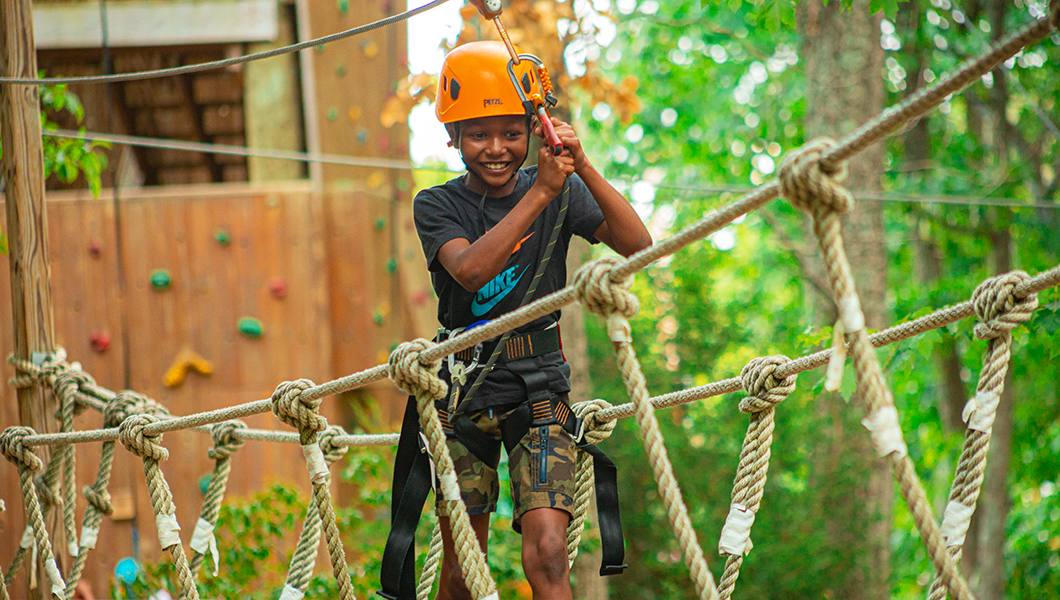 A boy on the Kids' Adventure Course at the Family Adventure Park at Massanutten Resort