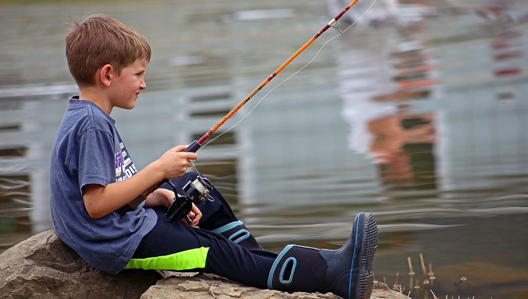 A boy fishing at Massanutten Resort