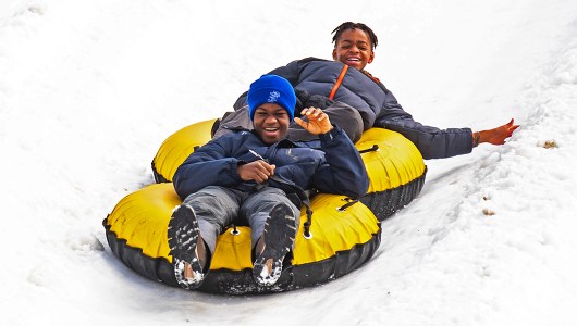 People Snowtubing