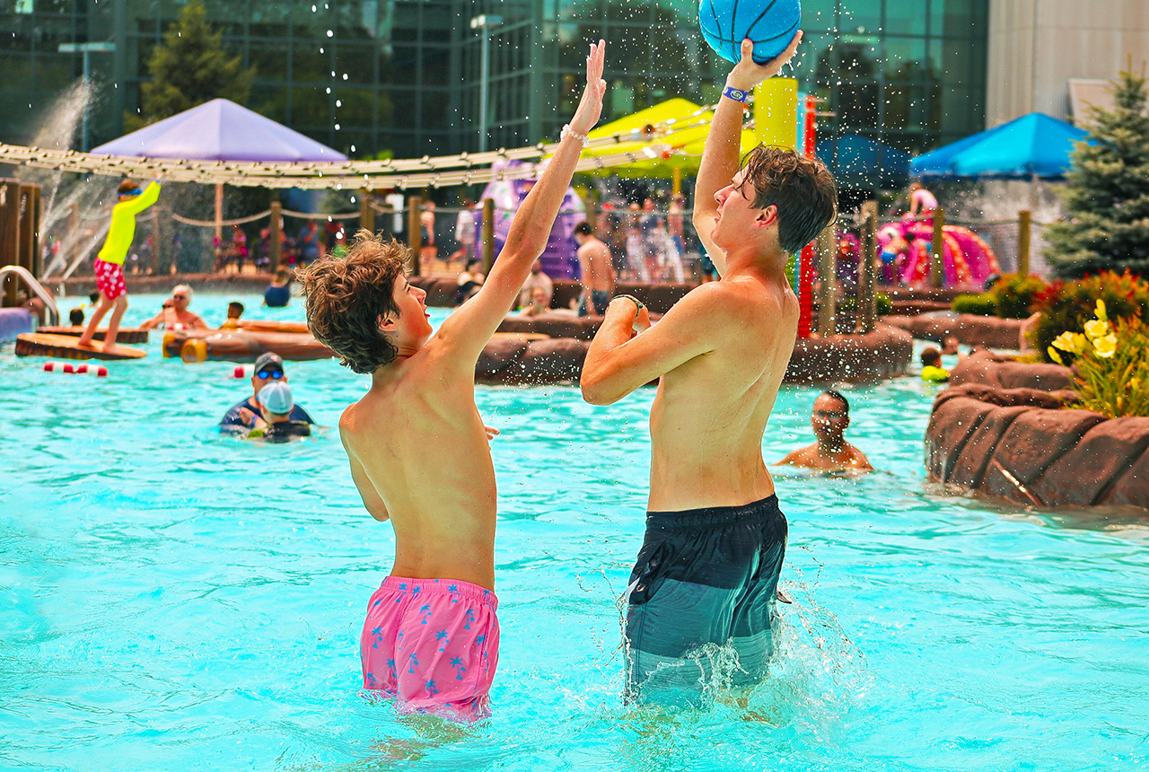 Guests playing basketball in the pool at the Outdoor WaterPark