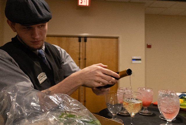 Employee pouring a glass