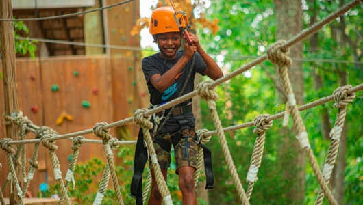 A guest on the Kids Adventure Course at the Massanutten Family Adventure Park