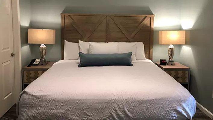 Interior photo of Woodstone Meadows condo king bed in primary bedroom